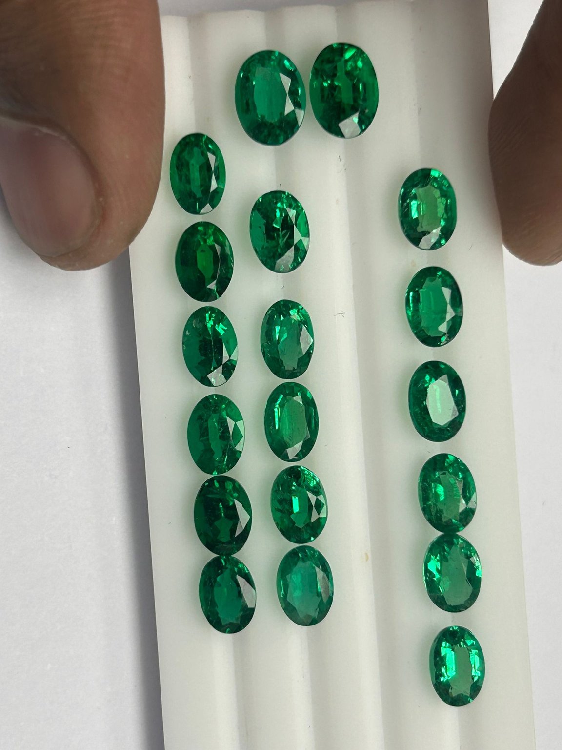 Calibrated oval-cut emeralds, matched parcel
