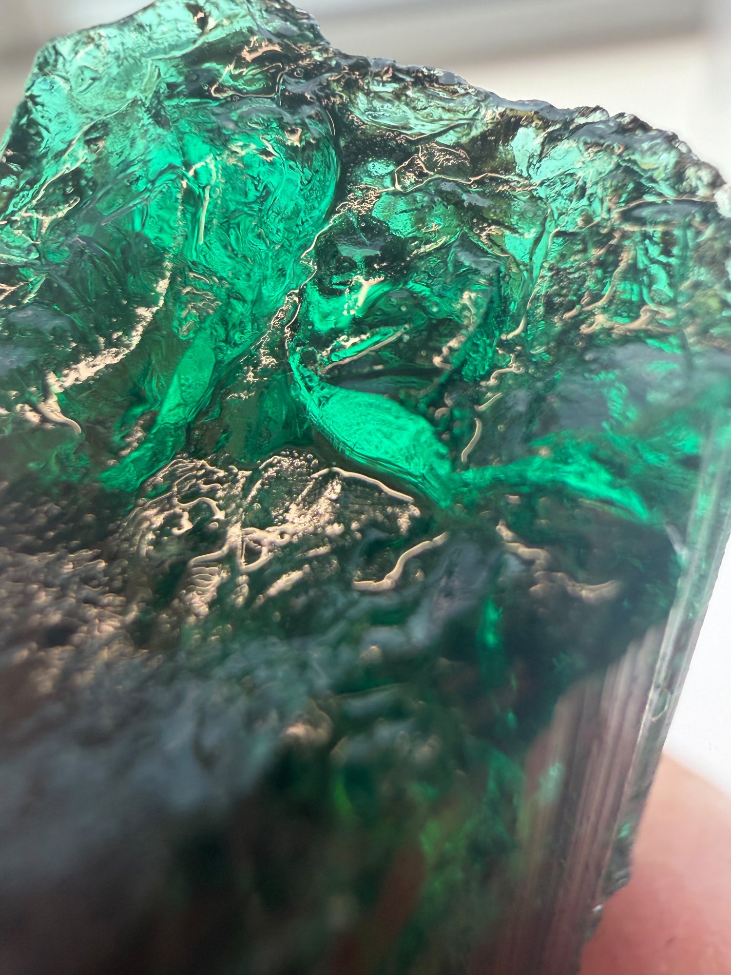 Rough emerald crystal being evaluated
